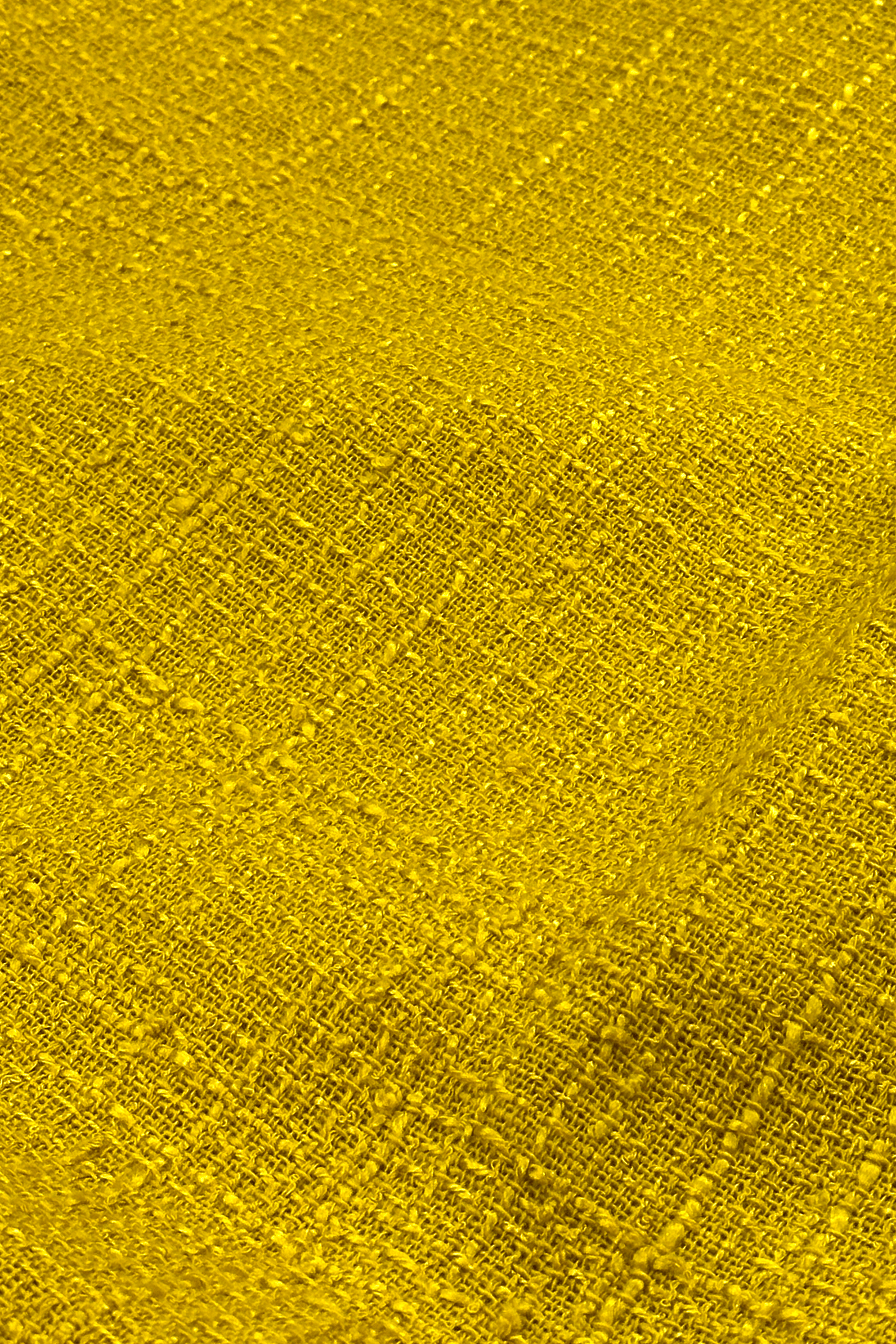 Close-up of a textured yellow fabric surface