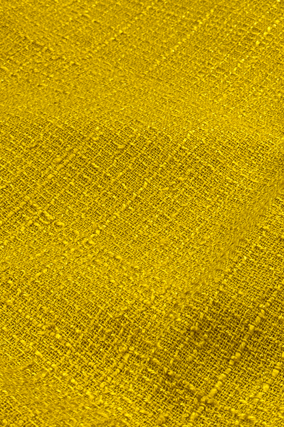 Close-up of a textured yellow fabric surface