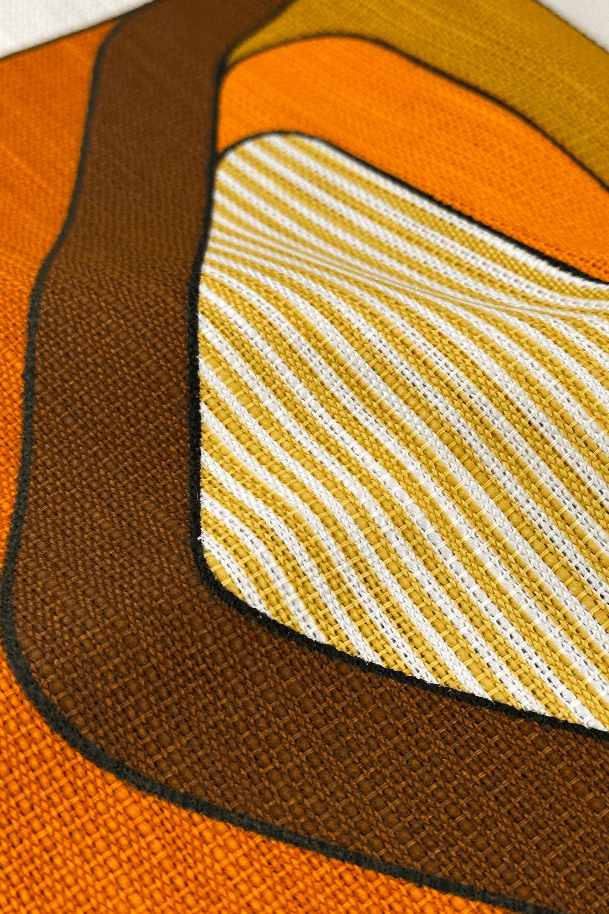 Close-up of a textured fabric with wavy pattern and solid colors