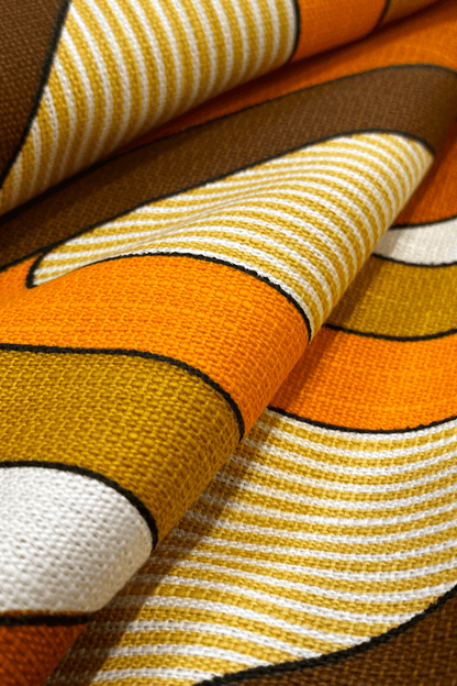 Close-up of fabric with orange, brown, and white pattern