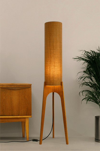 Mustard. Archie Rocket Floor Lamp - a handcrafted wooden floor lamp with a cylindrical shade in a mustard colour in a minimalist room.