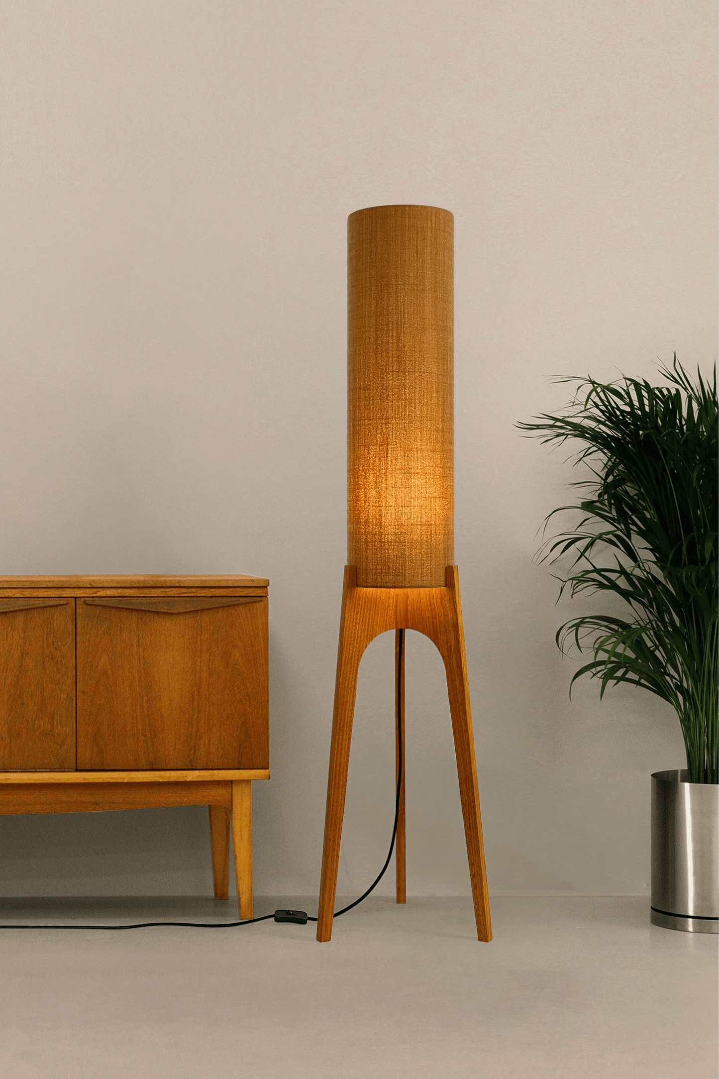Mustard. Archie Rocket Floor Lamp - a handcrafted wooden floor lamp with a cylindrical shade in a mustard colour in a minimalist room.