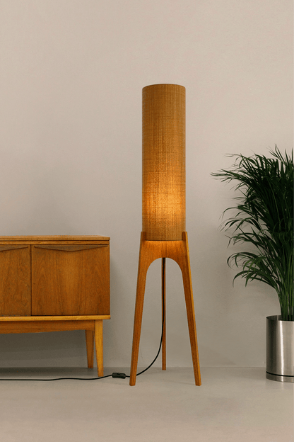 Mustard. Archie Rocket Floor Lamp - a handcrafted wooden floor lamp with a cylindrical shade in a mustard colour in a minimalist room.