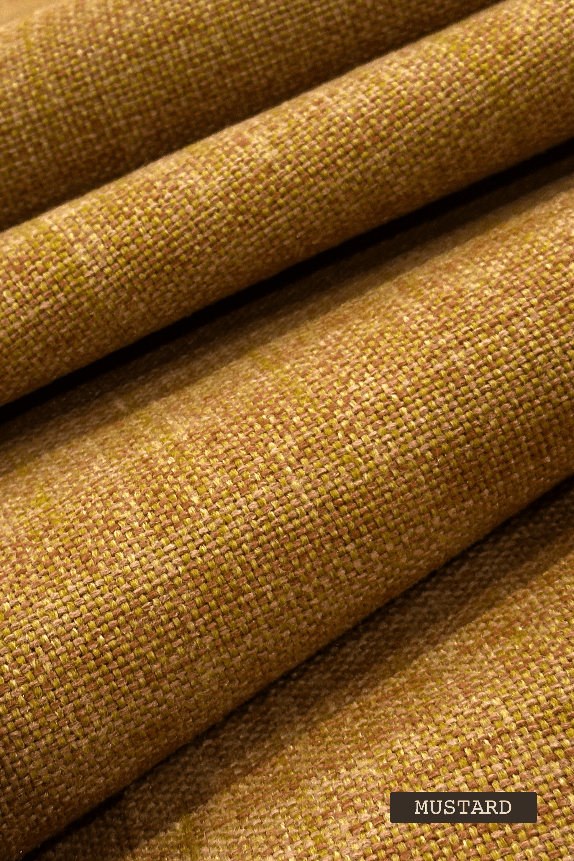 Close-up of mustard yellow fabric with a textured pattern