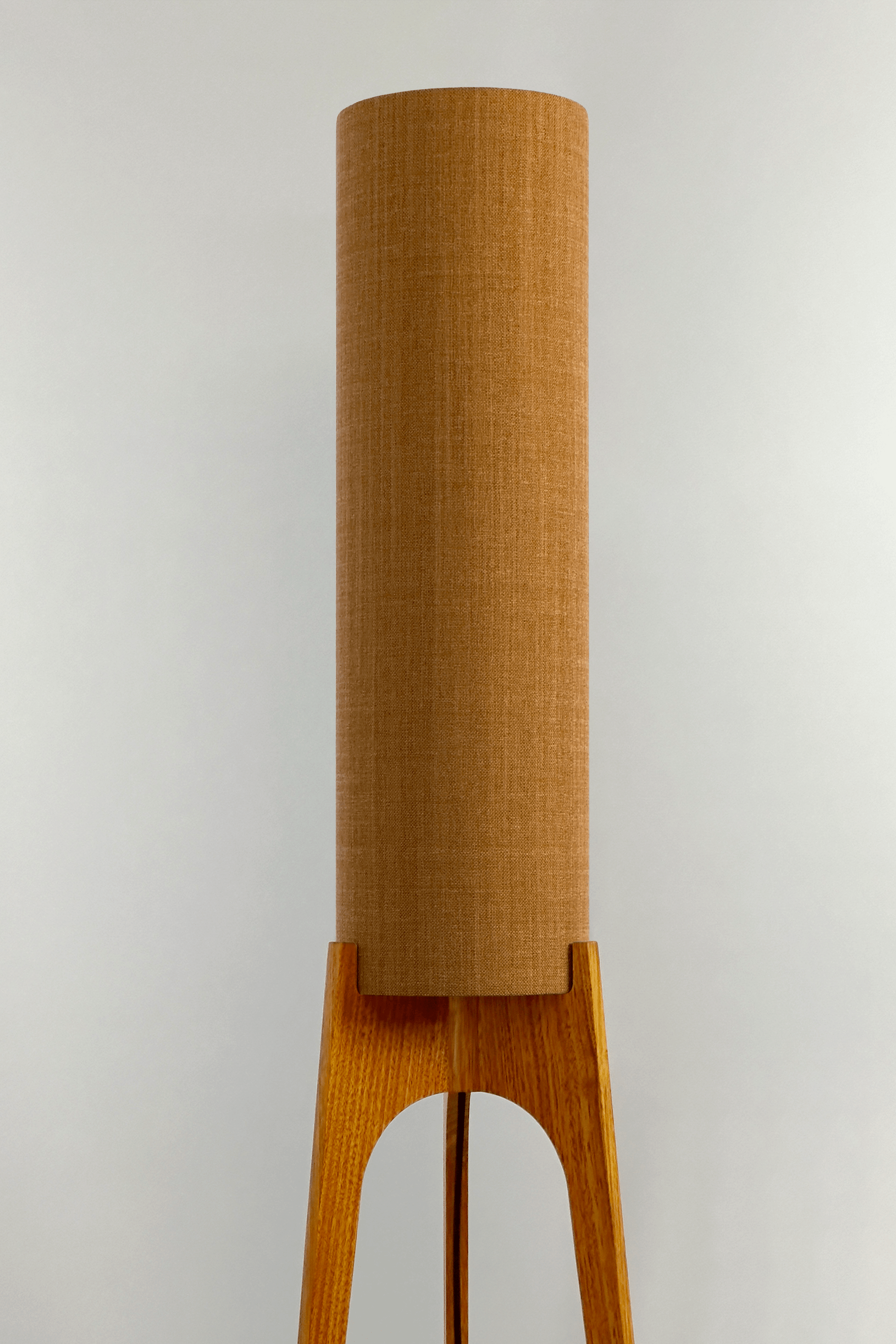 Mustard. Archie Rocket Floor Lamp - a handcrafted wooden floor lamp with a cylindrical shade in a mustard colour in a minimalist room.