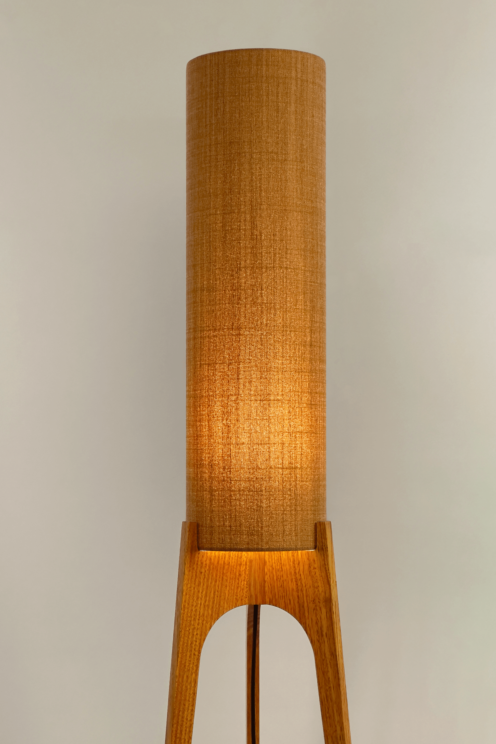 Mustard. Archie Rocket Floor Lamp - a handcrafted wooden floor lamp with a cylindrical shade in a mustard colour in a minimalist room.