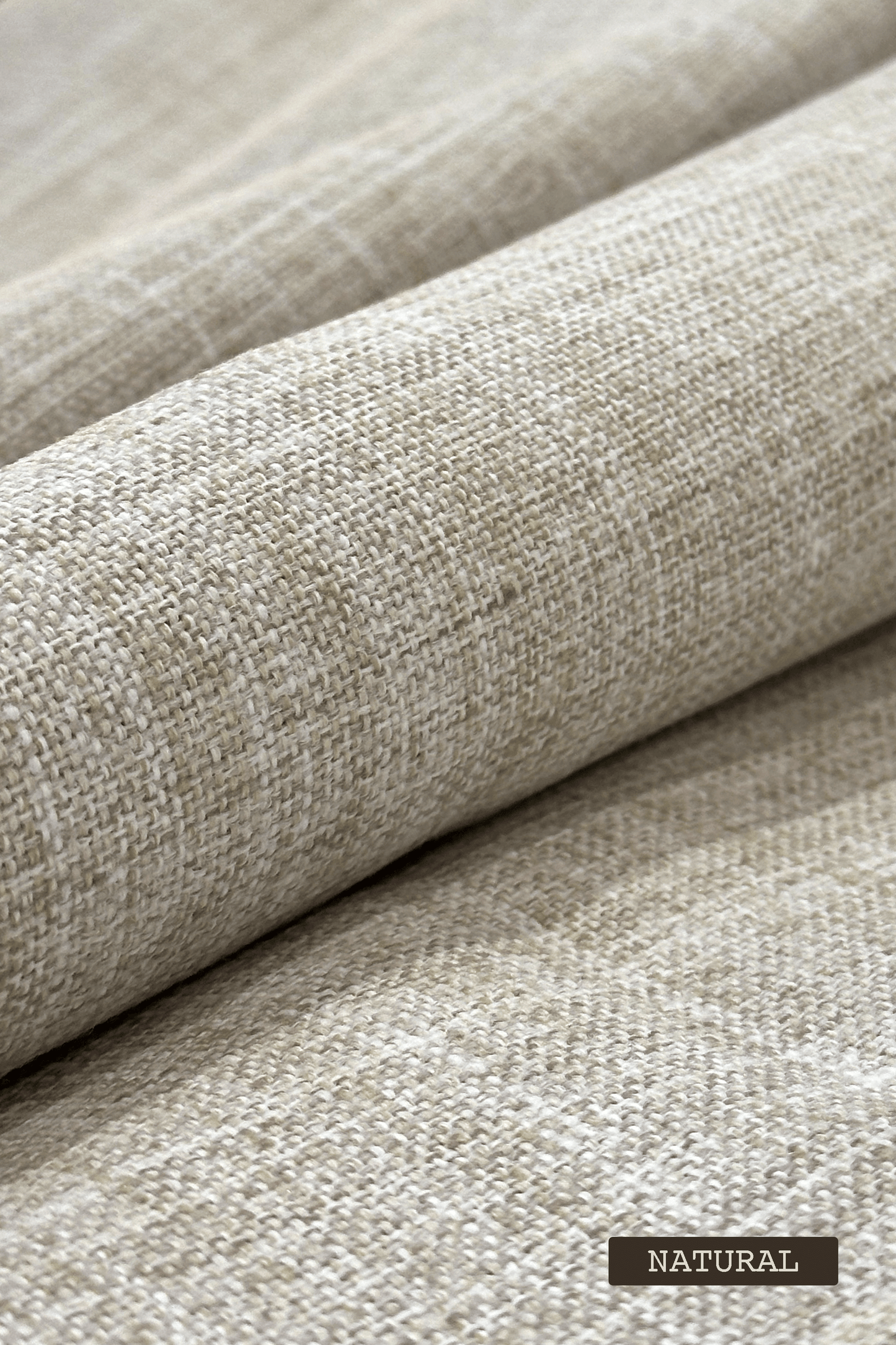 Close-up of textured beige fabric with 'NATURAL' label