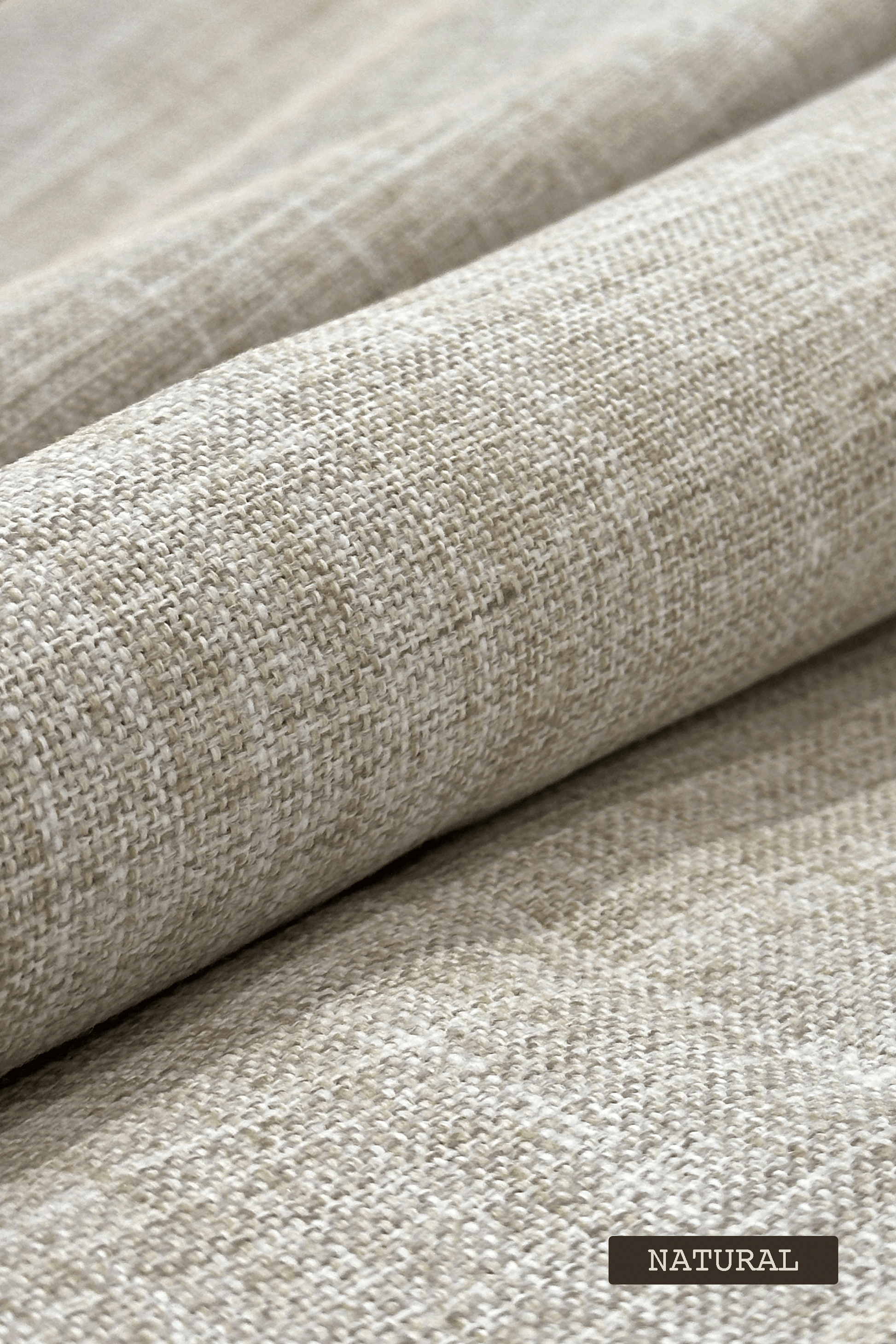 Close-up of textured beige fabric with 'NATURAL' label