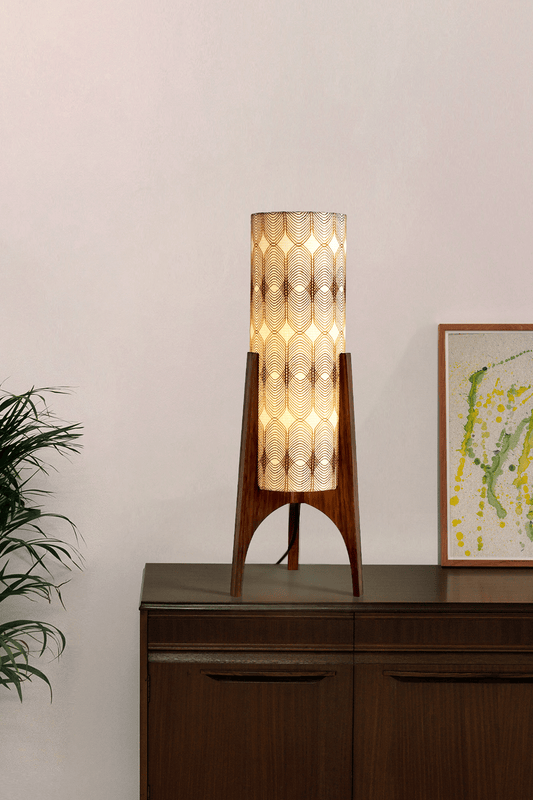 Noa - Archie Rocket Table lamp with a vintage woven fabric shade on a wooden cabinet against a white wall.