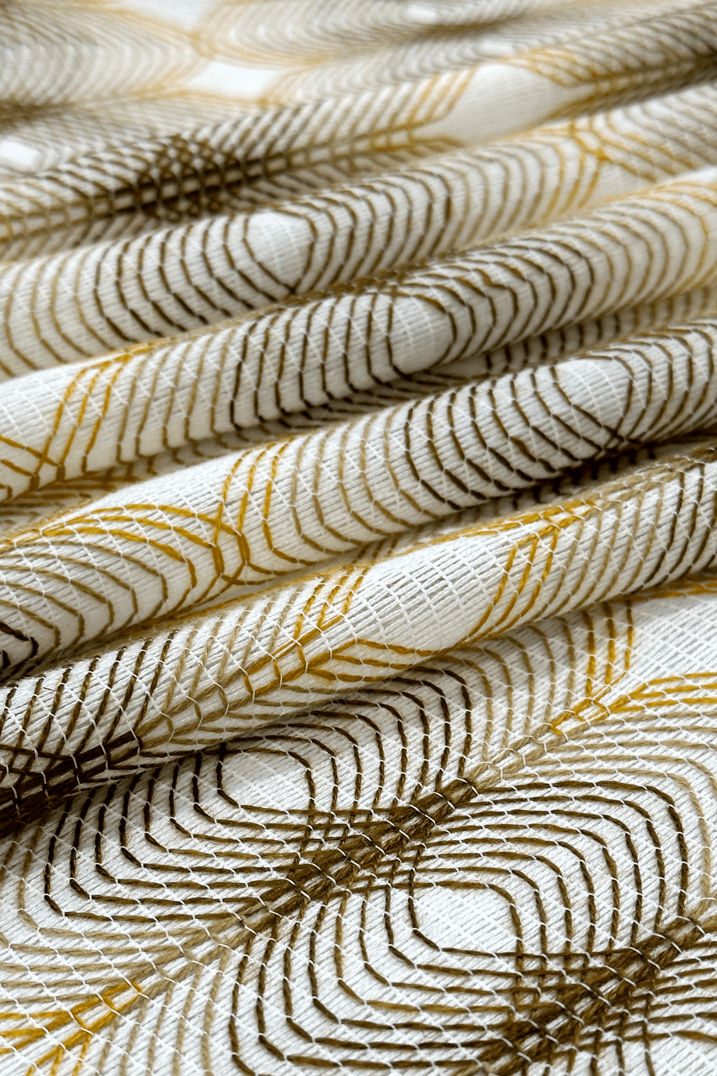 Close-up of textured fabric with gold and white pattern