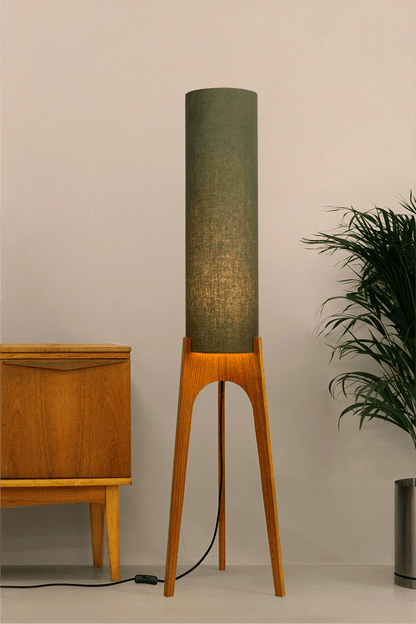 Handmade wooden Rocket Floor Lamp with cylindrical lampshade in Olive and wooden base in a mid-century room setting