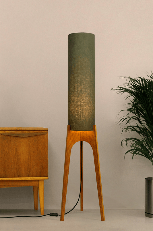 Handmade wooden Rocket Floor Lamp with cylindrical lampshade in Olive and wooden base in a mid-century room setting