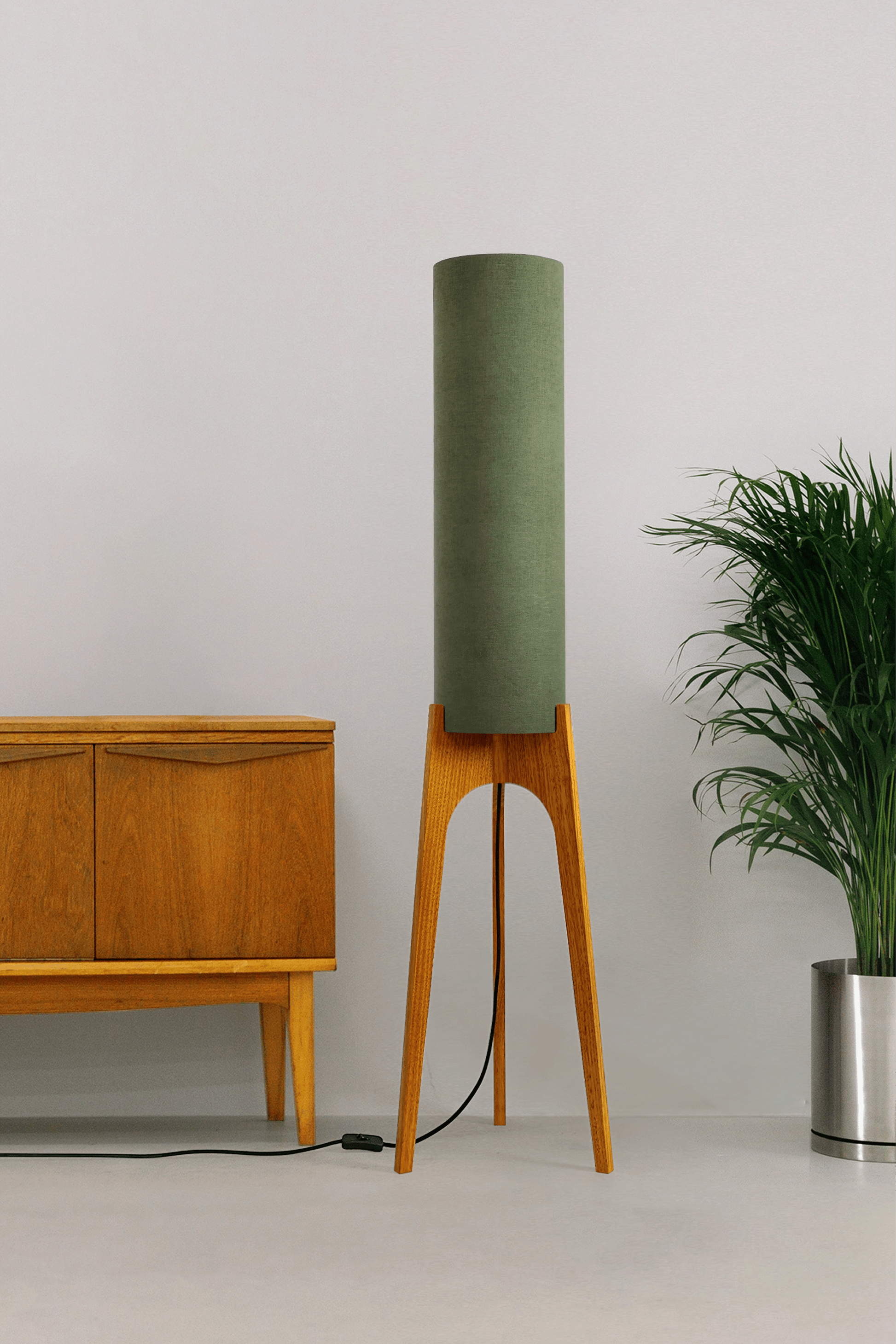 Handmade wooden Rocket Floor Lamp with cylindrical lampshade in Olive and wooden base in a mid-century room setting