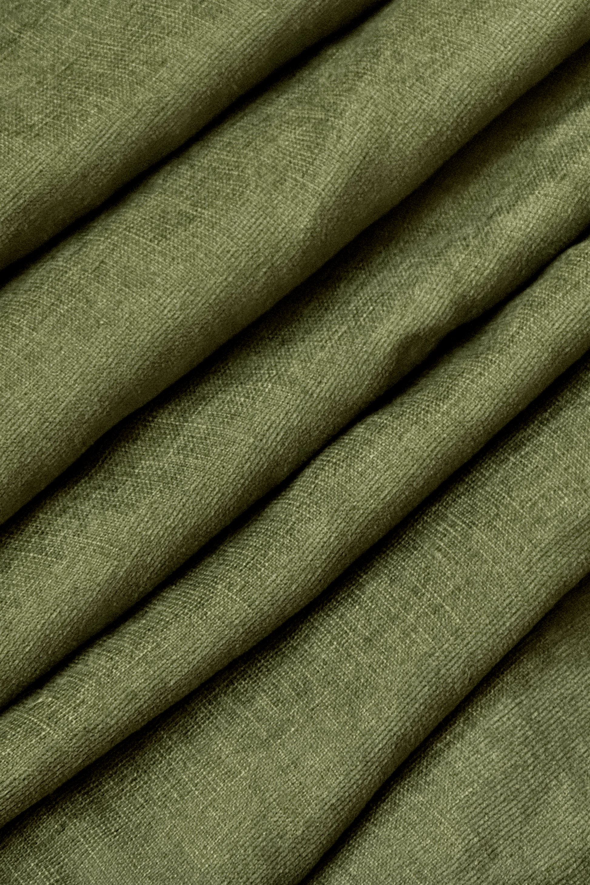 Close-up of olive green fabric with a textured pattern