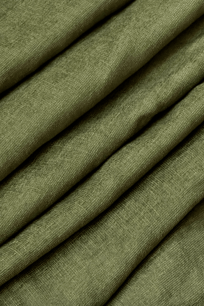 Close-up of olive green fabric with a textured pattern