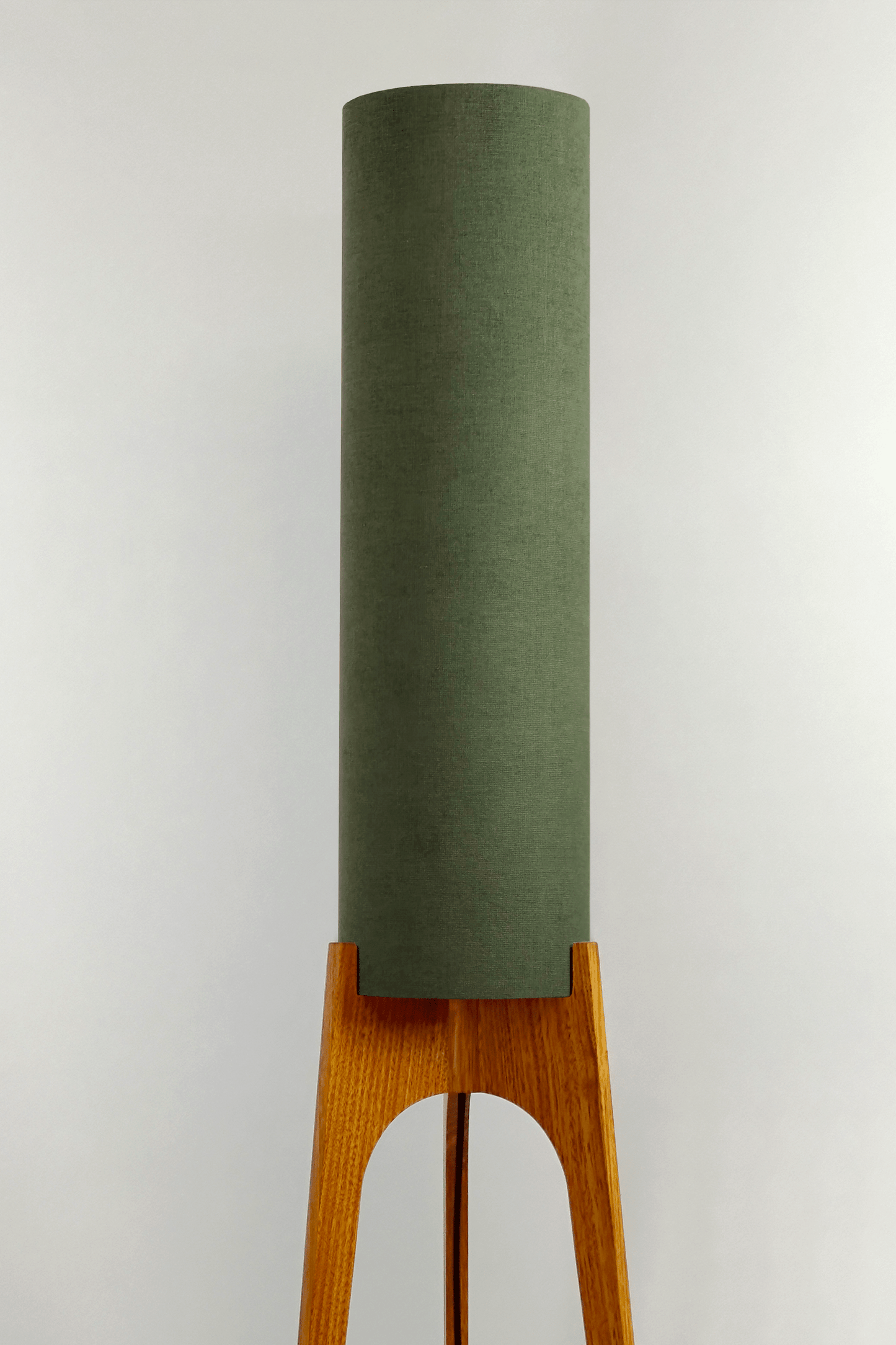 Handmade wooden Rocket Floor Lamp with cylindrical lampshade in Olive and wooden base in a mid-century room setting