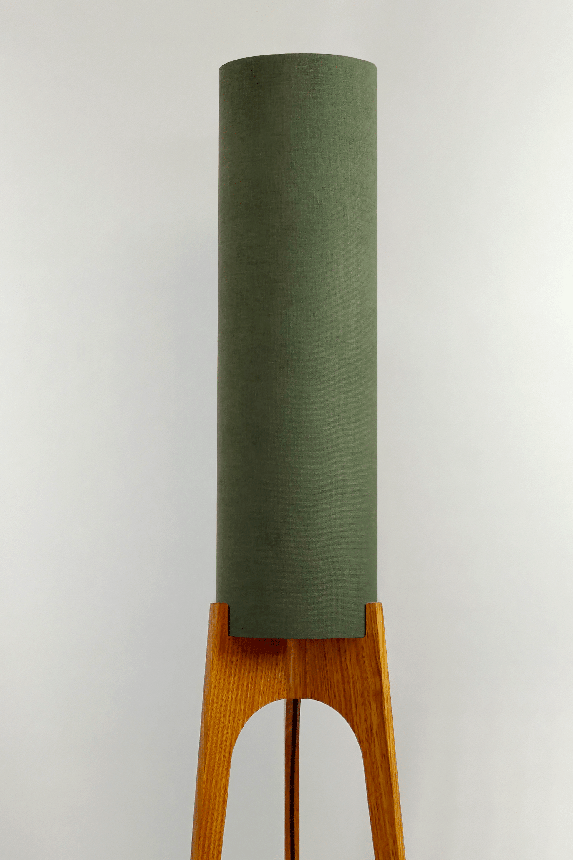 Handmade wooden Rocket Floor Lamp with cylindrical lampshade in Olive and wooden base in a mid-century room setting