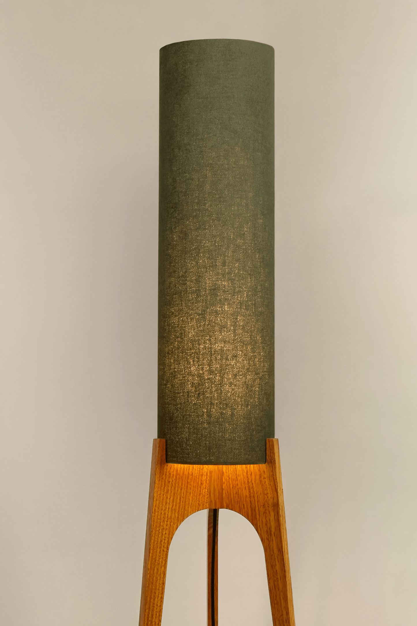 Handmade wooden Rocket Floor Lamp with cylindrical lampshade in Olive and wooden base in a mid-century room setting
