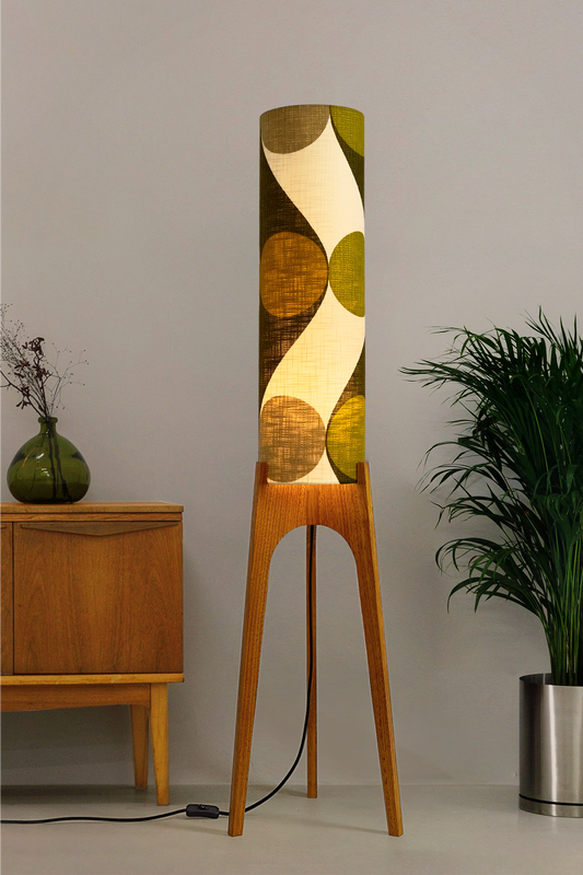 Olli - Archie Rocket Floor Lamp handmade by Retro Duo, from vintage geometric patterned fabric lampshade and wooden lamp base in a room with a wooden cabinet and plant.