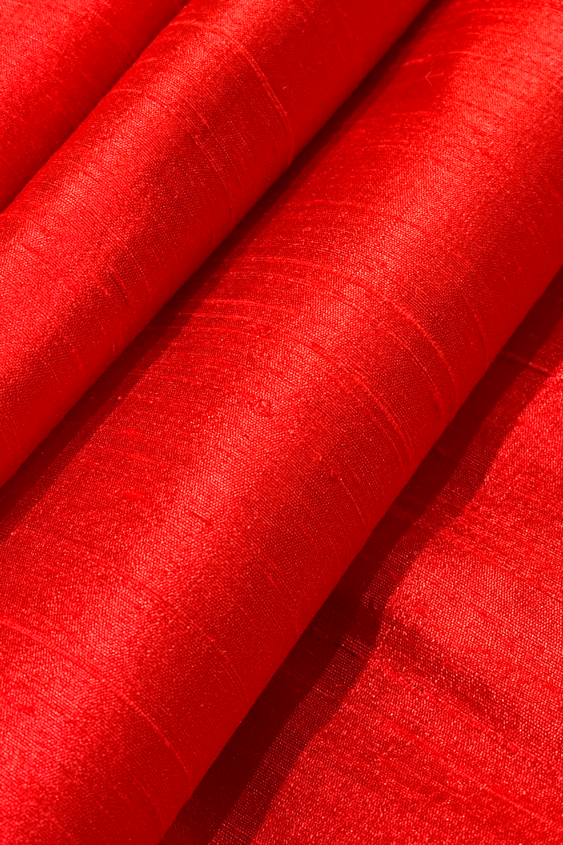 close up raw silk fabric in hibiscus red