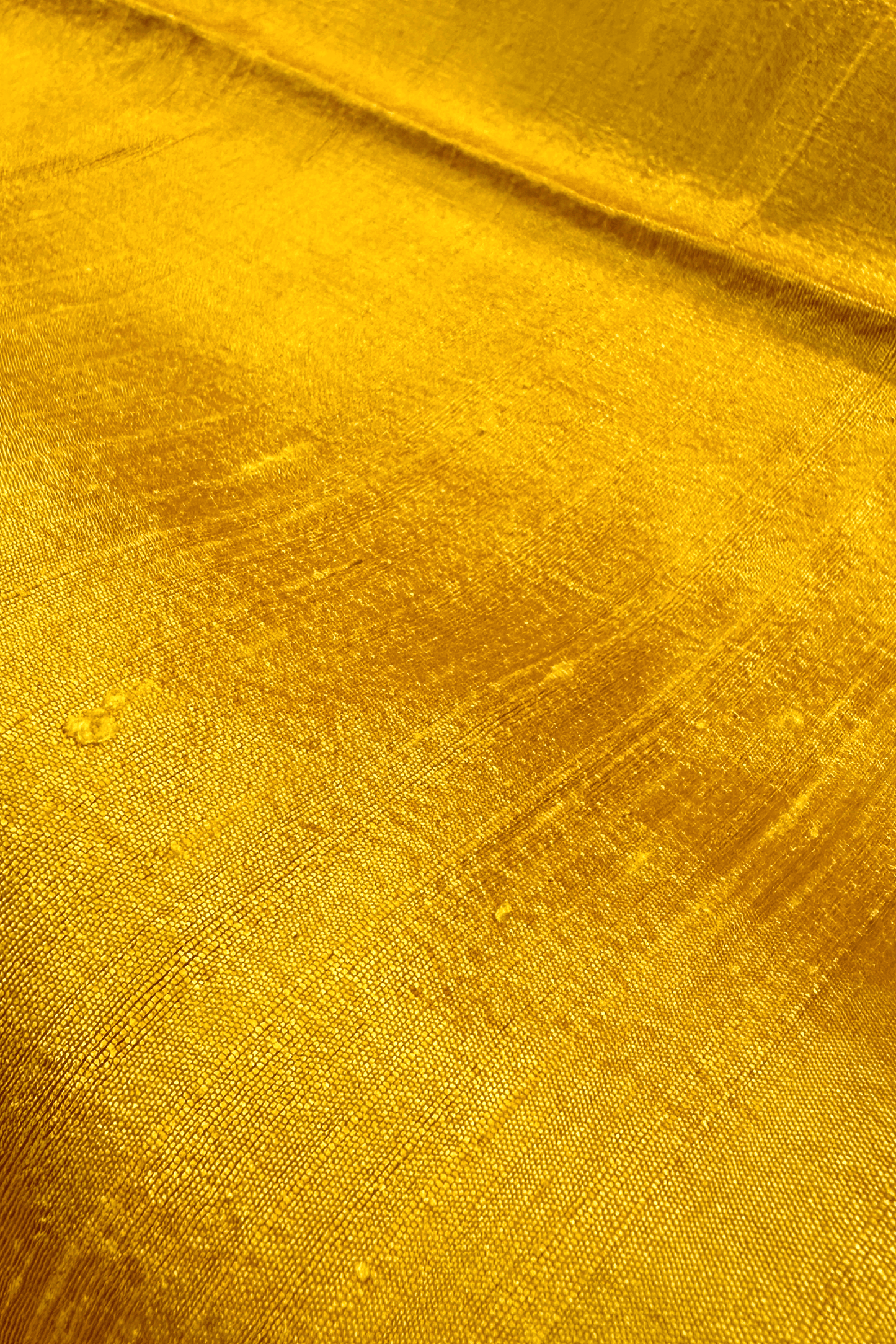 Close-up of saffron yellow raw silk fabric