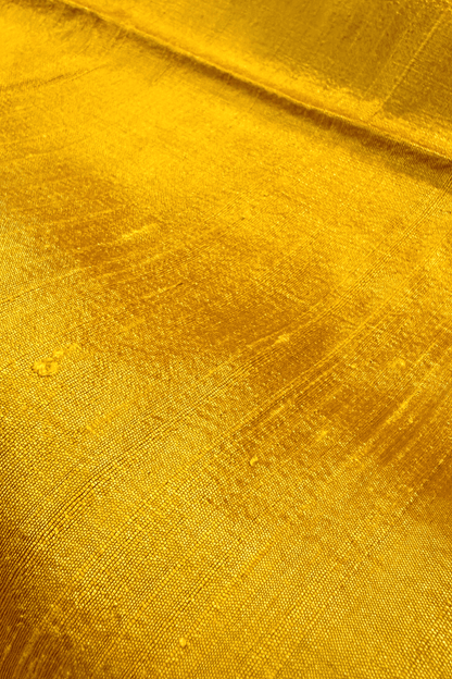 Close-up of saffron yellow raw silk fabric