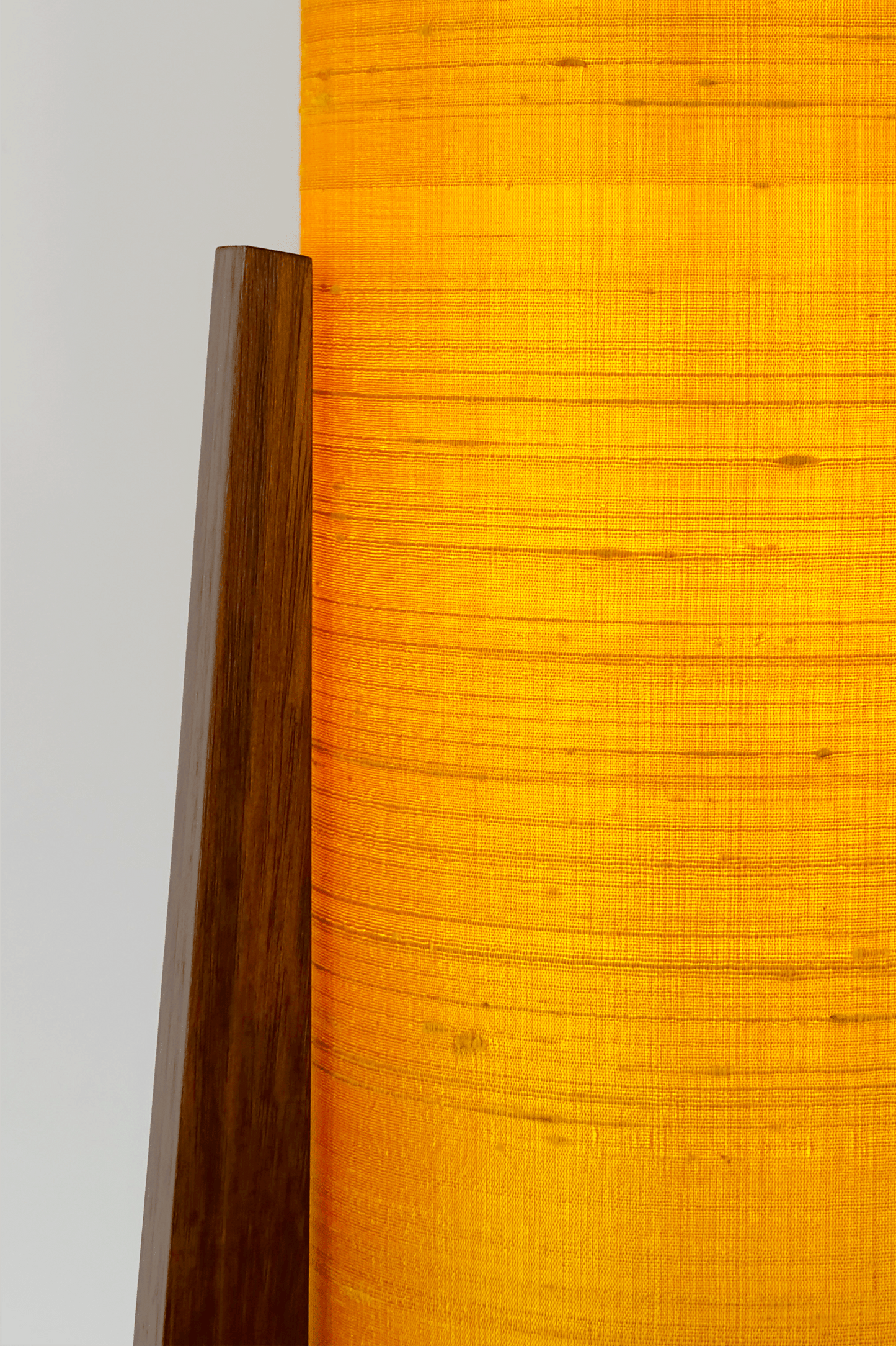 Close up Handmade Wooden Rocket Table Lamp with cylindrical handmade lampshade in premium raw silk, available in Saffron, Marigold, and Hibiscus colour options