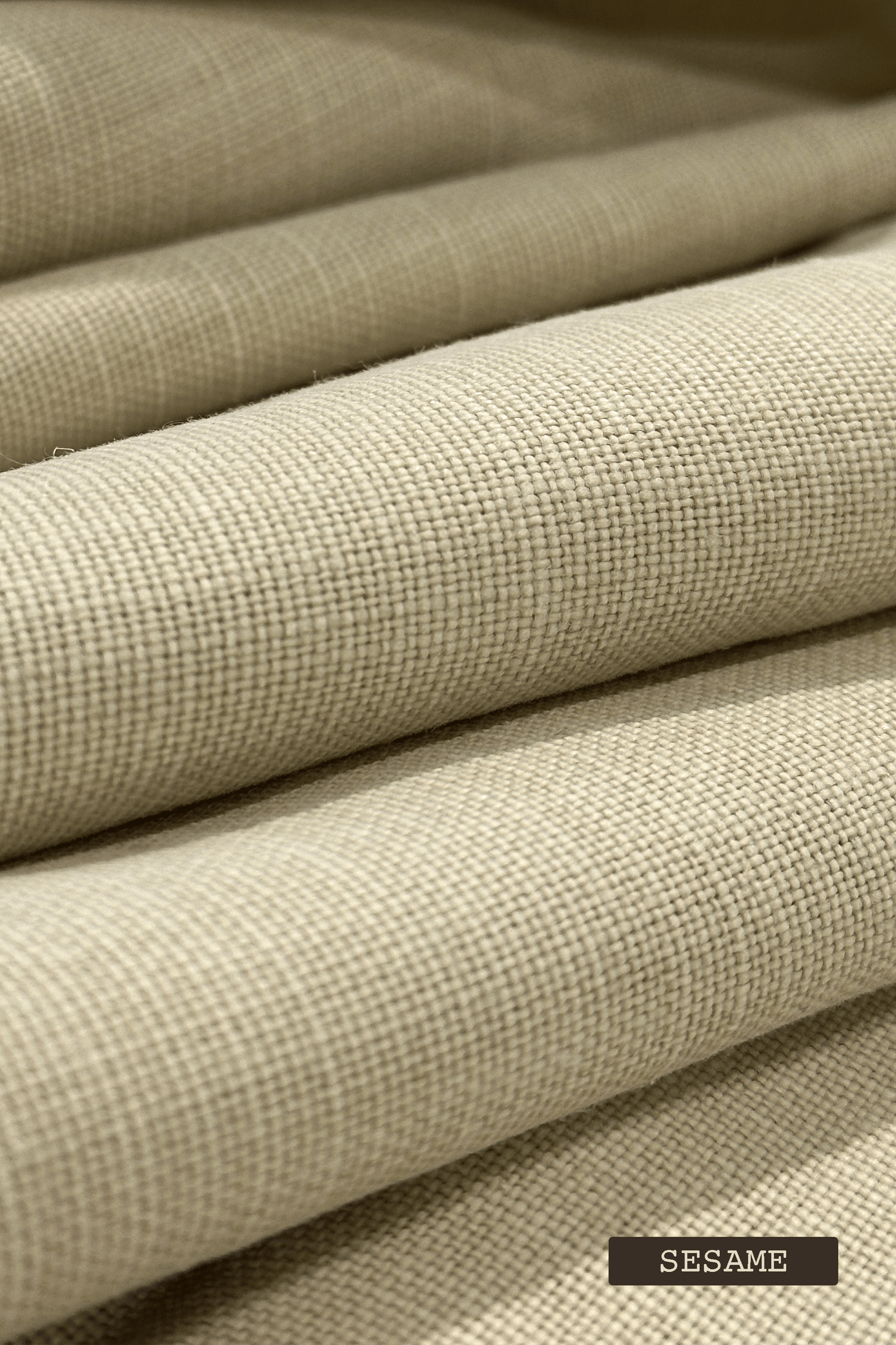 Close-up of linen fabric swatches with 'SESAME' label