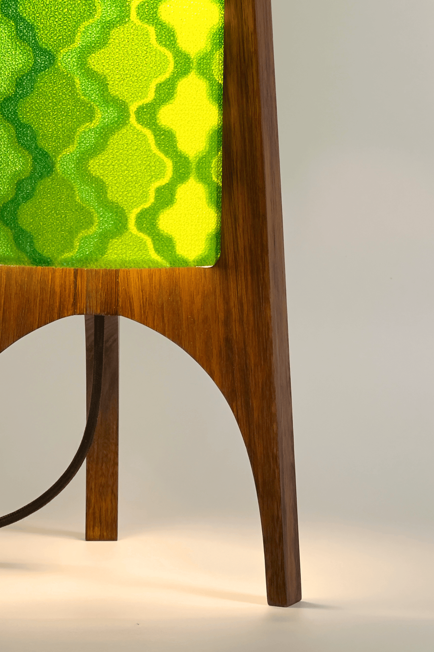 Close up of handmade Archie Rocket Table Lamp with yellow green geometric patterns lampshade made from vintage terry cloth and hardwood base