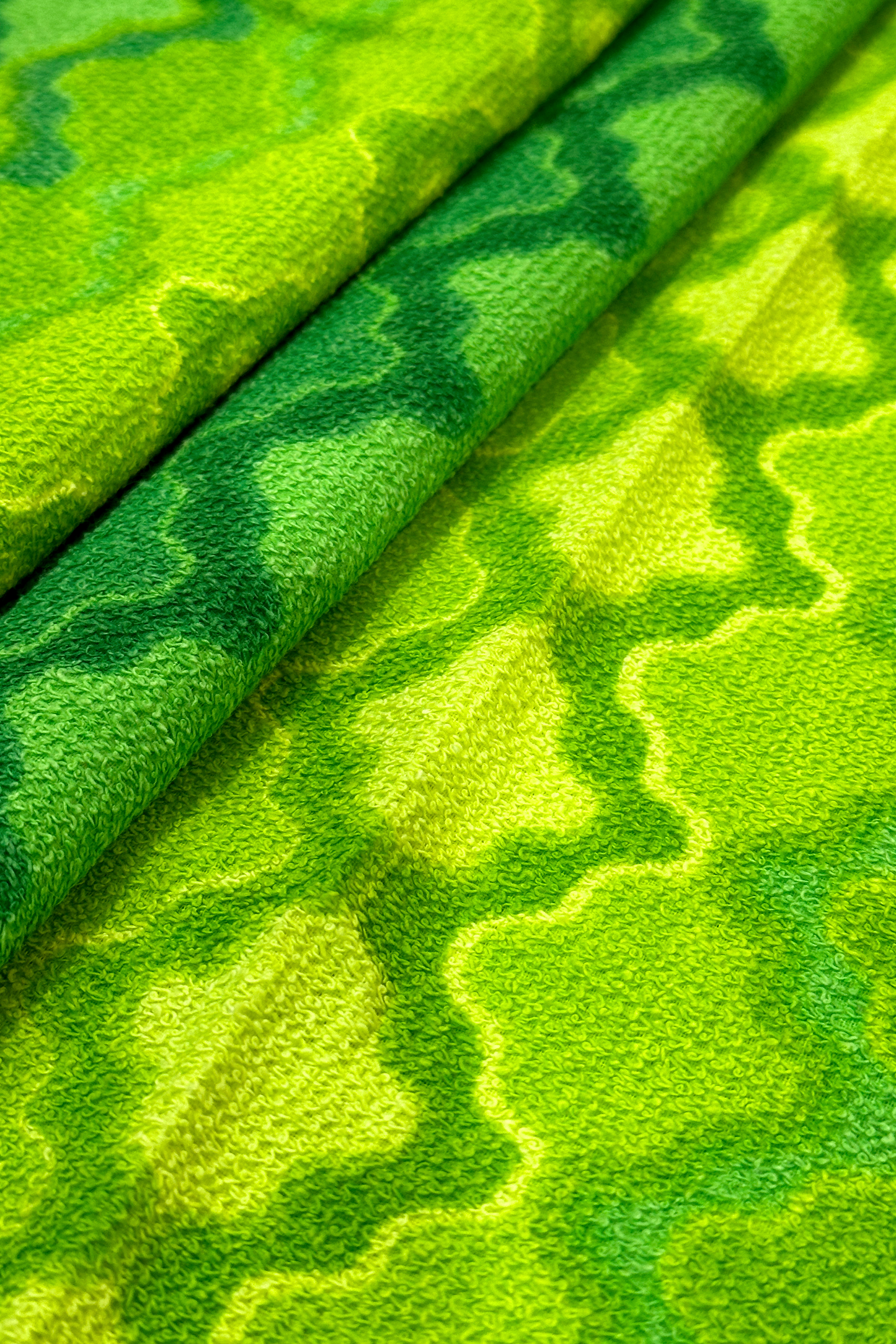 Vintage terry cloth fabric in green and yellow geometric patterns.