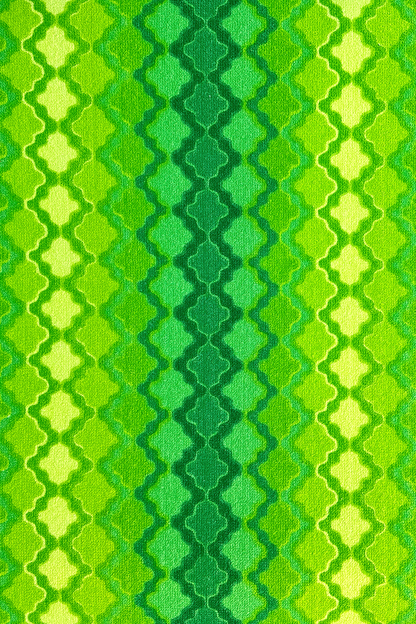 Vintage terry cloth fabric in green and yellow geometric patterns.