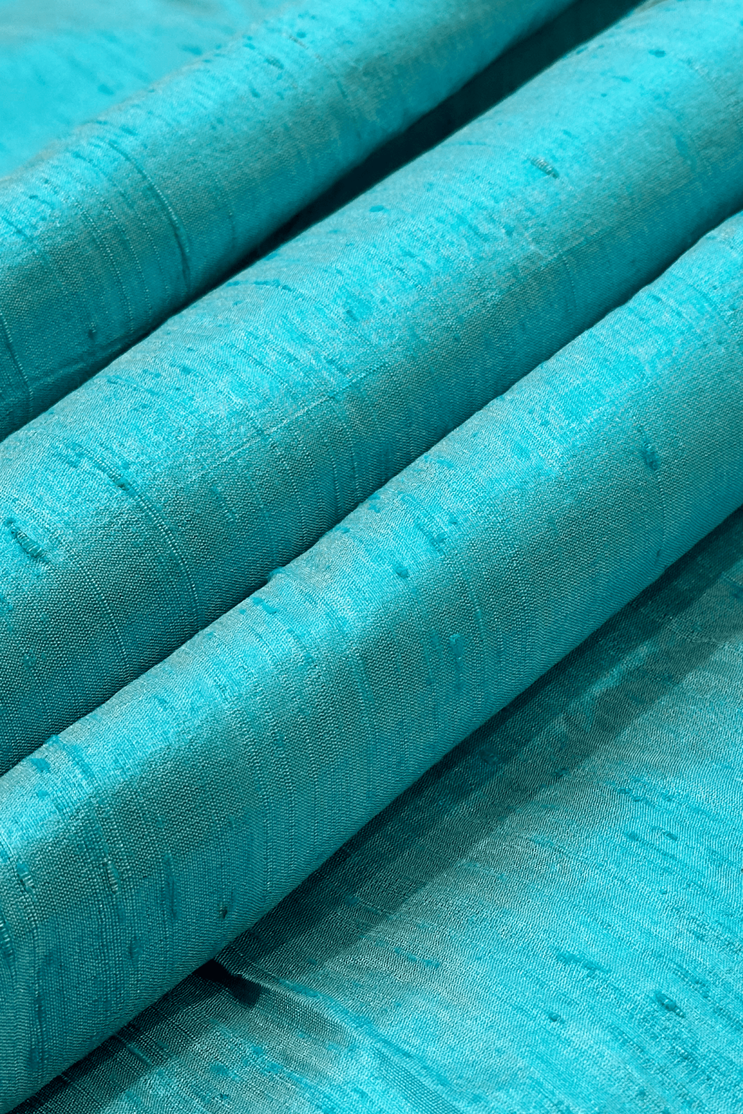 Close up raw silk fabric in turquoise 