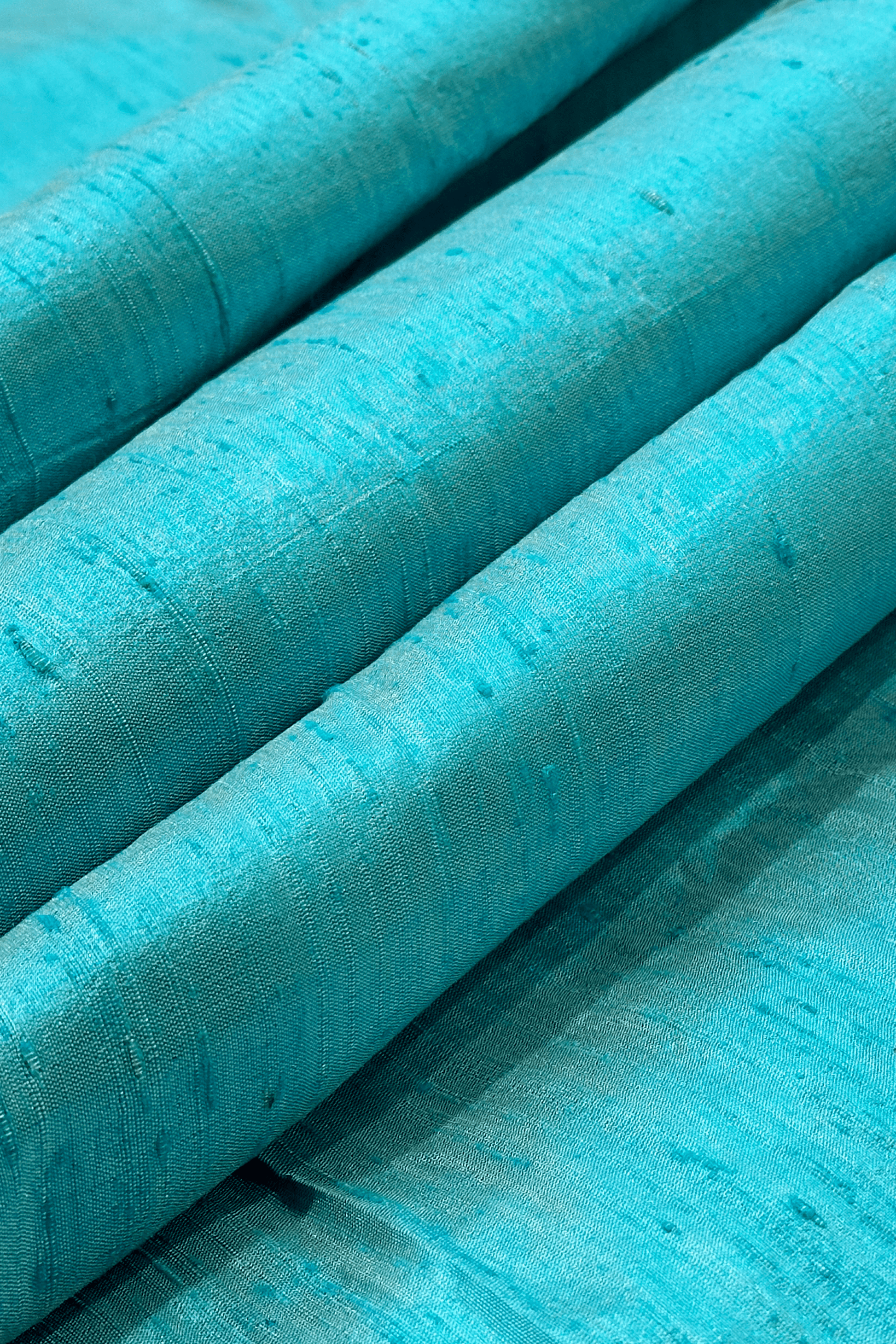 Close up raw silk fabric in turquoise 