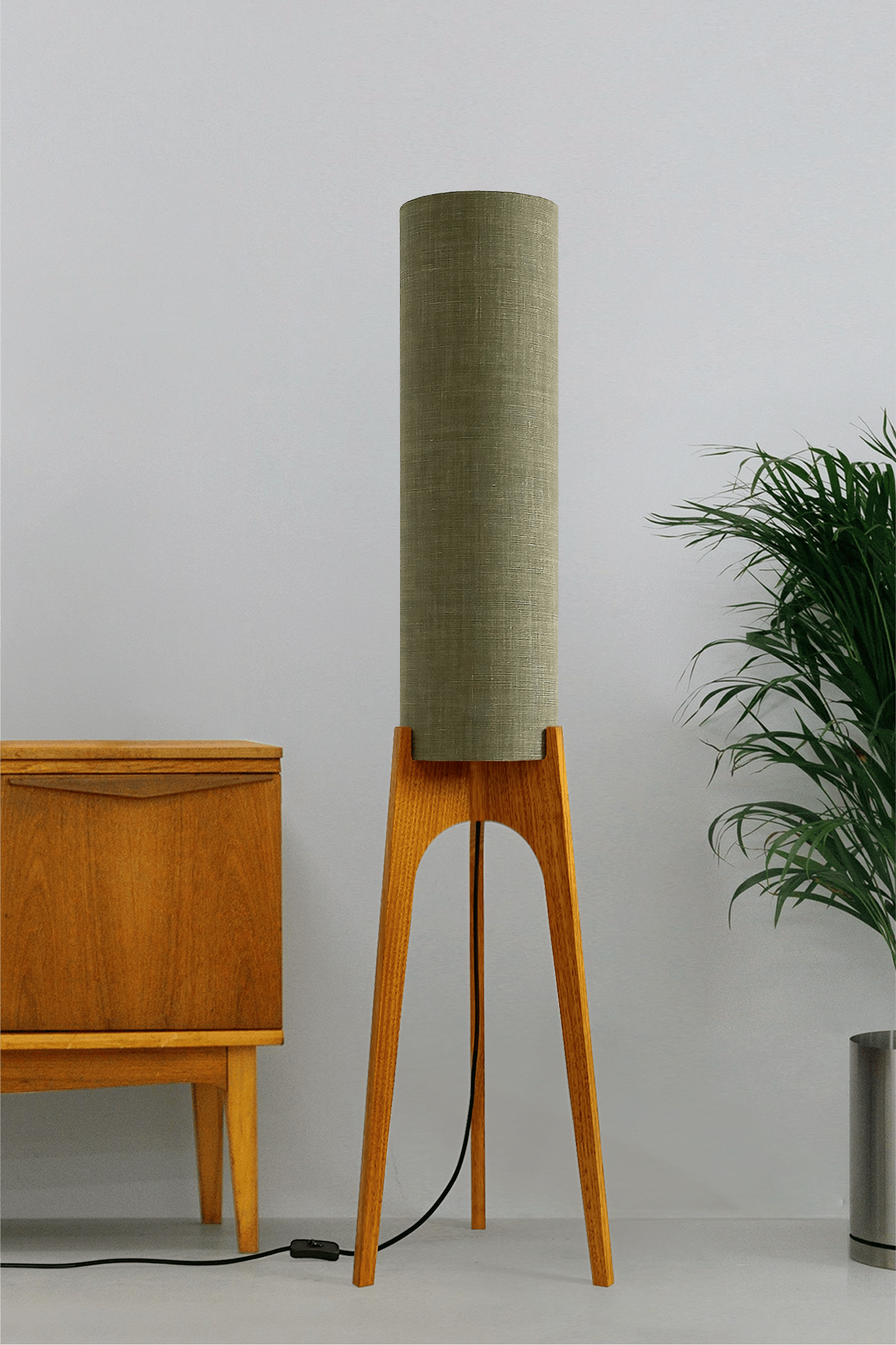 Tussock - Archie Rocket Floor lamp with wooden base and green fabric shade in a minimalistic setting.