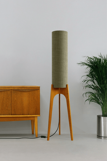 Tussock - Archie Rocket Floor lamp with wooden base and green fabric shade in a minimalistic setting.
