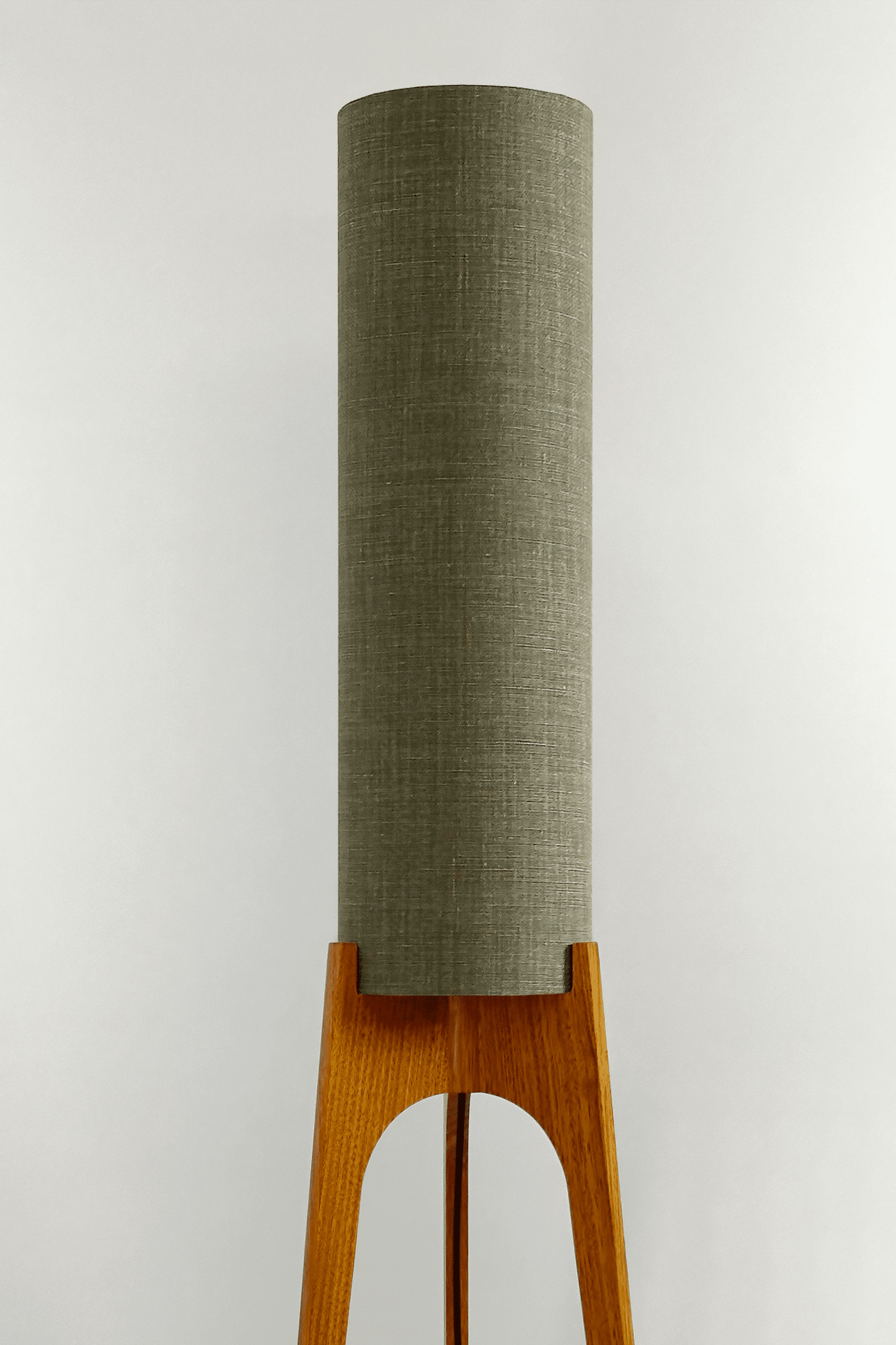 Tussock - Archie Rocket Floor lamp with wooden base and green fabric shade in a minimalistic setting.