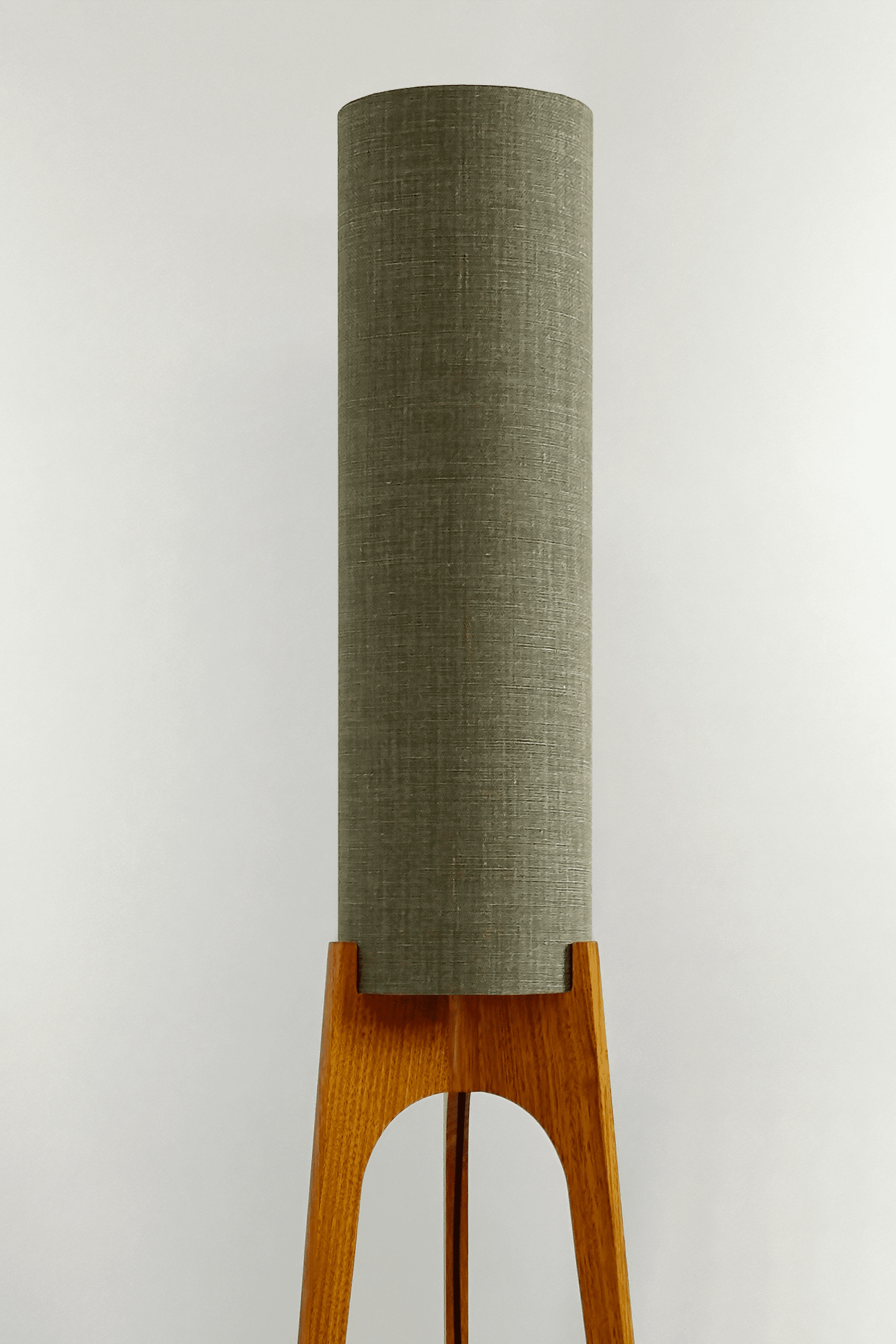 Tussock - Archie Rocket Floor lamp with wooden base and green fabric shade in a minimalistic setting.
