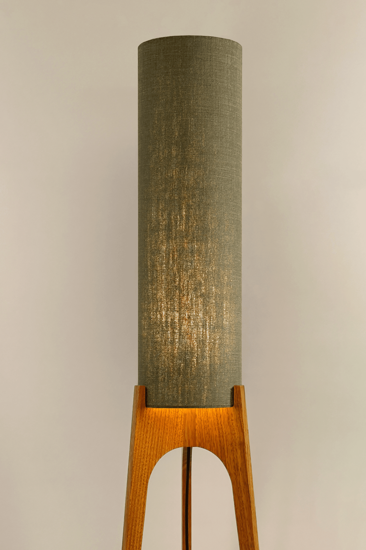 Tussock - Archie Rocket Floor lamp with wooden base and green fabric shade in a minimalistic setting.