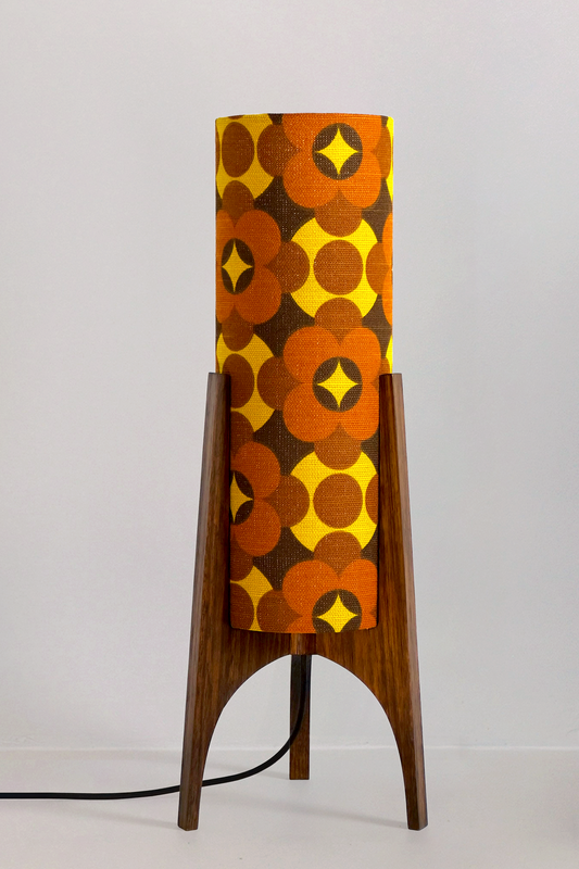 Coco - Archie Rocket Table lamp with a vintage geometric patterned fabric shade on a wooden cabinet against a white wall.