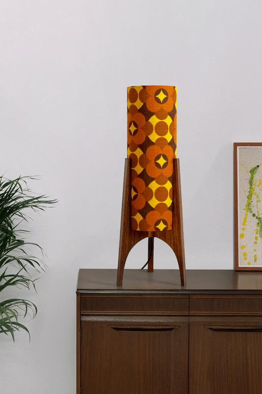 Coco - Archie Rocket Table lamp with a vintage geometric patterned fabric shade on a wooden cabinet against a white wall.